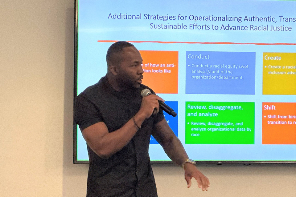 Photo of chris bijoux, CJJR’s deputy director for Equity and Racial Justice, leading a training on racial and ethnic disparities.