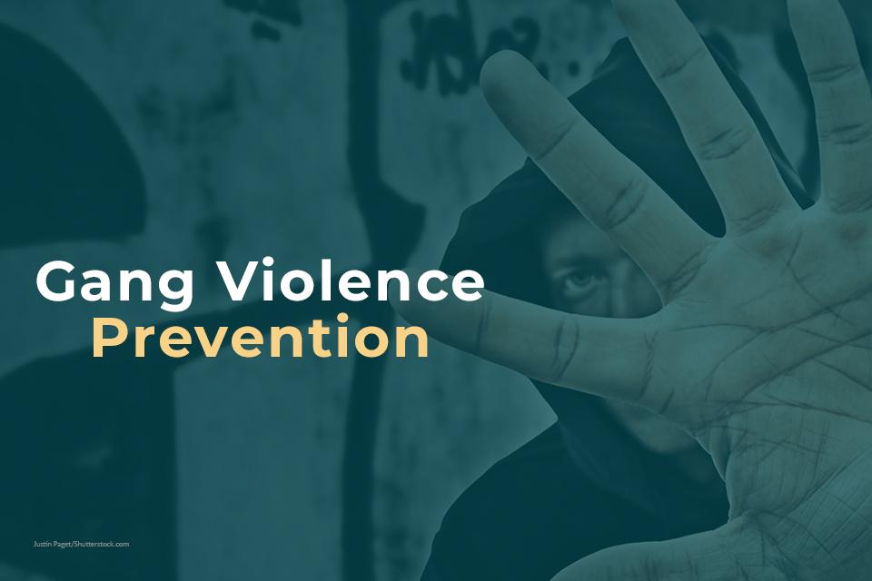 Gang Violence Prevention with image of male holding up hand in front of his face